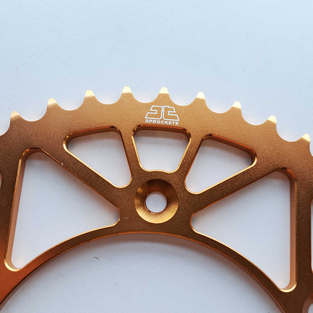 JT - Sprocket - Rear - JTA897/224U/TR130 - 520 - KTM 125-530 90-26, Husqvarna 125-501 14-26, Gas Gas 125-450 21-26, Triumph 250/450 24-26, STARK - Orange